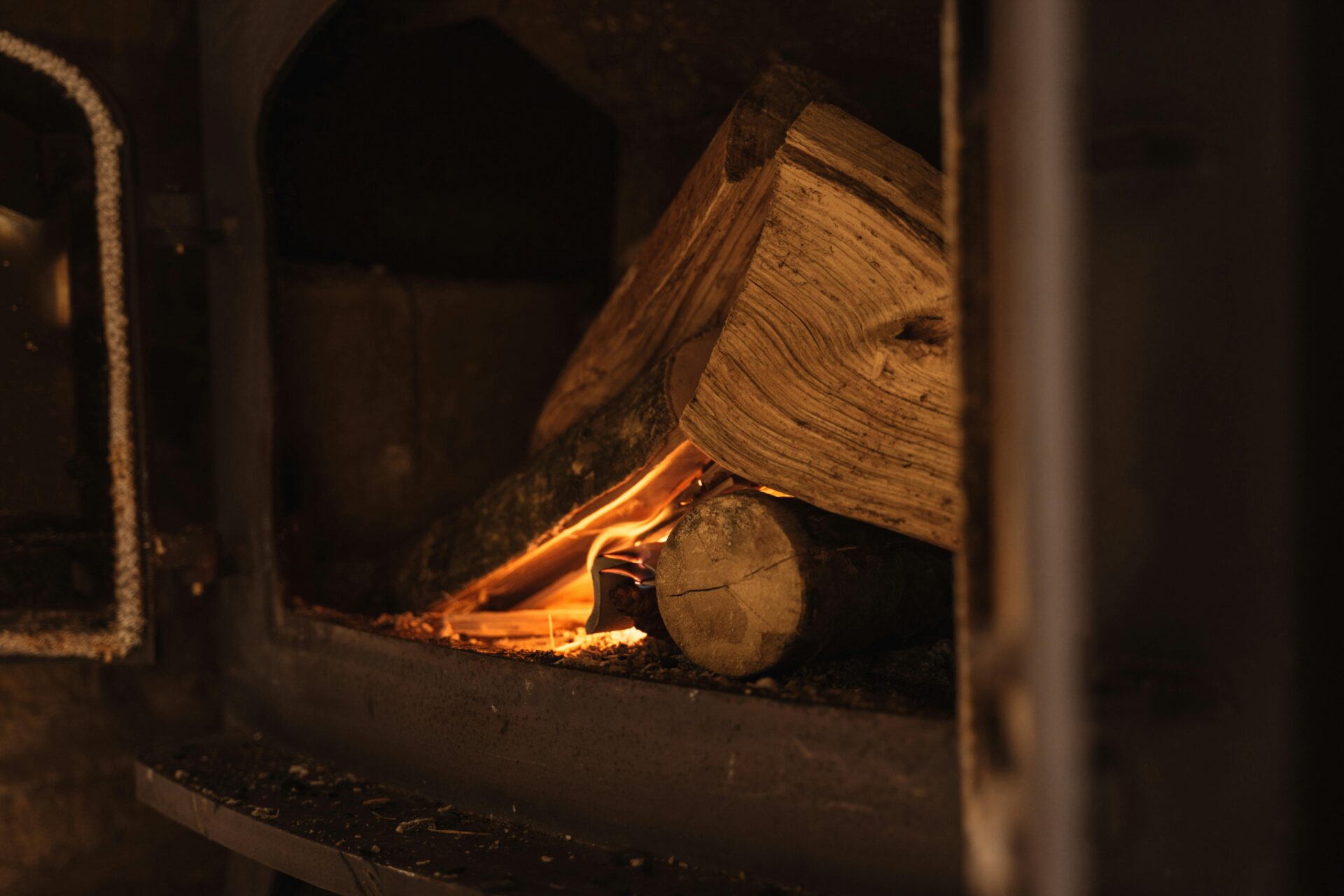 A fire is lit inside a wood burning stove